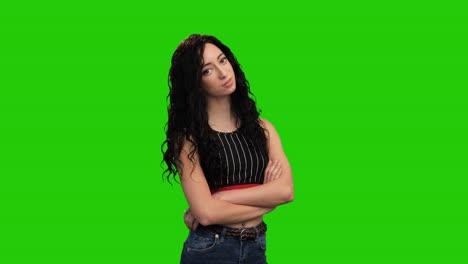 Confident-woman-with-long-curly-hair-crosses-hands-posing-on-green-screen