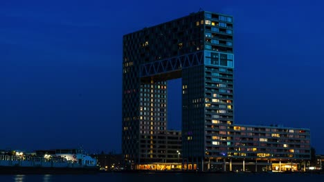 A-wide-day-to-night-timelapse-of-the-exterior-of-the-Pontsteiger-building-in-Amsterdam-during-sunset-on-a-sunny-day