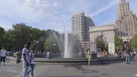 People-walking-around-the-fountain-in-Washington-Square-Park-in-New-York-City