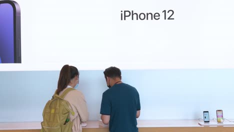 A-customer-being-assisted-by-an-Apple-employee-as-the-American-technology-brand-has-launched-its-new-iPhone-12-and-iPhone-12-Pro-smartphones-in-Hong-Kong
