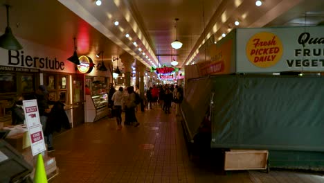 People-Wearing-Face-Mask-Walking-At-Pike-Place-Market-During-COVID-19-In-Seattle,-Washington,-United-States