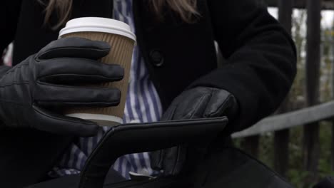 Business-woman-with-briefcase-and-takeout-coffee-close-up-shot
