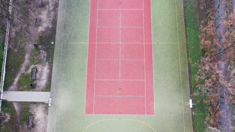 Birdseye-Aerial-View-of-Empty-Abandoned-Tennis-and-Futsal-Playground-and-Field