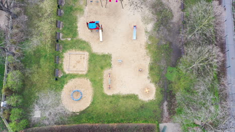 High-Angle-Aerial-View,-Empty-Deserted-Children-Playground-During-Covid-19-Virus-Outbreak-and-City-Lockdown,-Top-Down-Drone-Shot