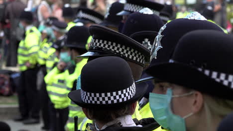 London-Metropolitan-police-officers-in-protective-face-masks-stand-in-line-on-a-cordon-while-policing-a-climate-change-protest-during-the-Coronavirus-pandemic