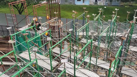Construction-workers-fabricating-steel-reinforcement-bar---timber-formwork-at-the-construction-site
