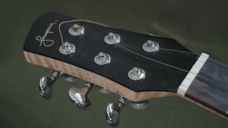 Removing-Strings-From-The-Headstock-Machine-Heads-Of-An-Acoustic-Guitar---close-up