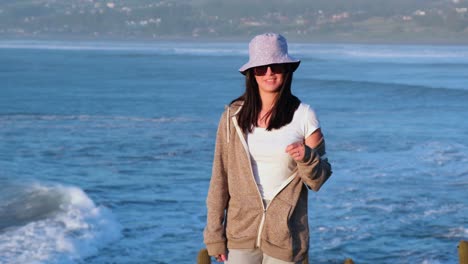 beautiful-girl-portrait-with-bucket-hat-on-the-beach,-pichilemu,-punta-de-lobos