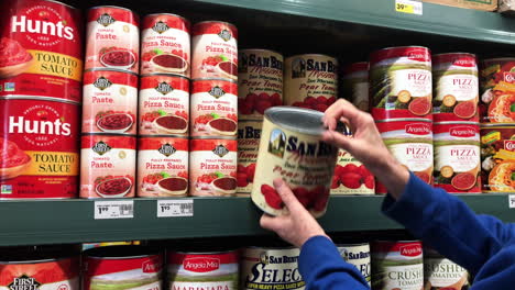 Image-Of-Hands-Customer-Grabs-A-Can-Of-Tomato-Sauce-At-Smart-Foodservice-In-Coos-Bay,-Oregon