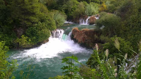 Large-waterfall-pouring-from-one-blue-pond-to-another-blue-pond-in-Krka-National-Park-in-Croatia