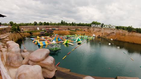 Panoramic-View-Of-Multicolored-Inflatable-Obstacle-Course-And-Slides---Grand-Canyon-Water-Park-In-Chiang-Mai,-Thailand---wide-panning-right-shot