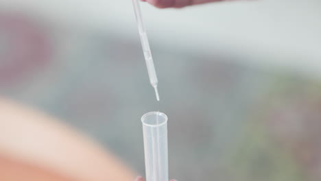 Droplets-Of-Lysis-Buffer-From-Pipet-Into-Plastic-Test-Tube-For-COVID-19-Test