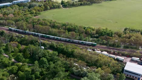 slider-drone-shot-following-southern-railway-class-377-train-through-north-west-London