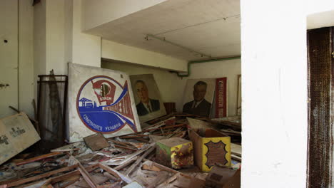 Posters-and-people-portrait-in-derelict-room-of-commercial-building-in-Pripyat