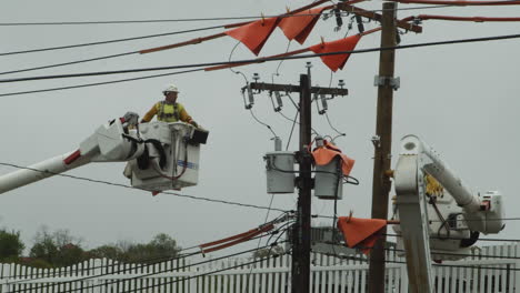 Close-up-electricians-working-on-internet-phone-cables-on-boom-lift-cherry-picker