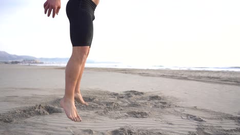 Man-doing-functional-exercises-training-on-the-beach-in-slow-motion
