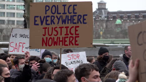 A-cardboard-placard-that-says,-“Police-everywhere,-justice-nowhere”-is-raised-on-a-Sisters-Uncut-protest-against-violence-on-women-outside-New-Scotland-Yard-in-London-during-the-Coronavirus-pandemic