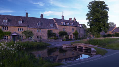 This-footage-shows-A-clapper-bridge-across-the-River-Eye-and-the-Old-cottages-in-Lower-Slaughter,-Cotswold,UK