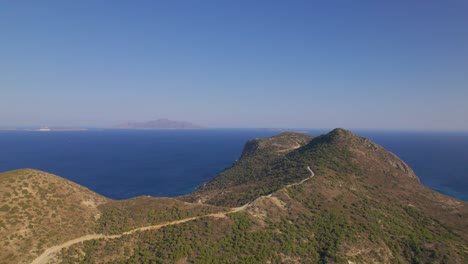 Aerial-view-approaching-mountain-and-blue-sea,-Kos,-Greece