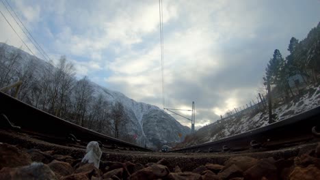 Low-wide-angle-train-passing-on-railroad-tracks-point-of-view---winter-Season