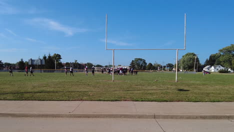 High-school-football-team-practicing-hard-for-the-first-big-game-of-the-season-on-a-sunny-afternoon