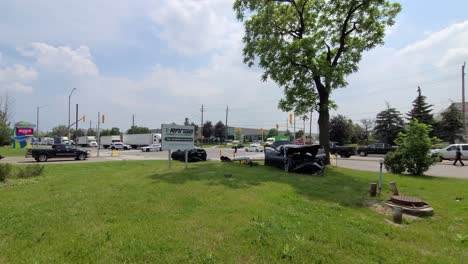 Wide-shot-of-vehicles-collision-at-the-intersection-of-Bovaird-Drive-East-Brampton-Canada-on-6th-June-2021,-car-remains-at-the-scene-and-police-car-blocked-at-the-intersection-to-control-traffic