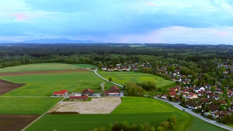 Timelapse-of-an-aerial-view-over-a-springtime-green-village-in-southern-bavaria---Oberhaching