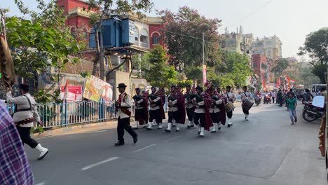 Static-view-of-a-youth-band-marching-and-playing-musical-instruments-on-the-road-followed-by-the-TMC-party-procession-to-woo-voters-ahead-of-Kolkata-civic-polls-in-a-winter-afternoon