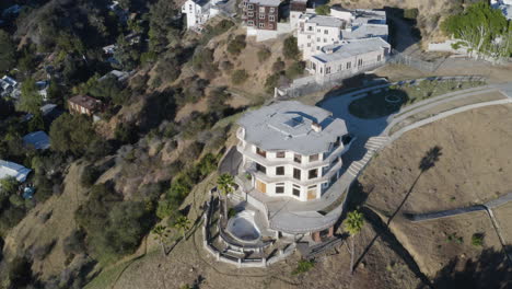 Aerial-above-creepy-abandoned-hillside-mansions-in-Los-Angeles