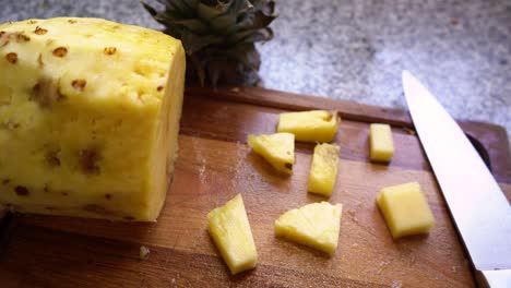 Chopped-Pineapple-Fruit-On-Wooden-Board-With-Knife