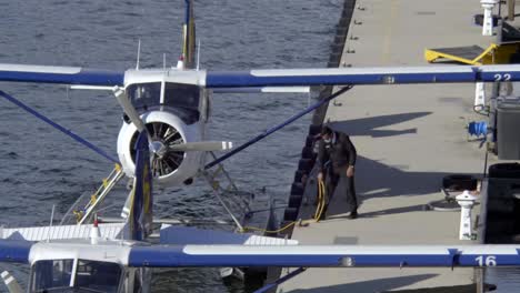 Men-Mooring-Floatplane-In-The-Bollard-At-Vancouver-Harbour-Flight-Centre-In-Canada