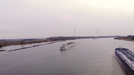 Aerial-Dolly-Across-Tanker-Ship-With-River-Princess-Cruise-Ship-Approaching-On-Cloudy-Day-On-Oude-Maas