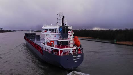Aerial-Parallax-From-Port-Side-And-Stern-Of-Ameland-Cargo-Ship-Travelling-Through-Oude-Maas