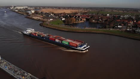 Aerial-View-Of-Missouri-Inland-Container-Vessel-Traveling-Along-River-Noord
