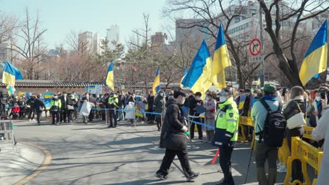 Ukrainian-demonstrators,-holding-banners-and-Ukrainian-flags,-protested-Russia's-invasion-in-Ukraine-in-front-of-the-Russian-embassy-in-Seoul