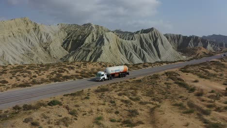 Aerial-View-Of-Oil-Tanker-Driving-Along-Coastal-Road-In-Hingol-National-Park