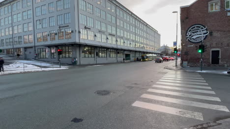 Static-shot-in-Trondheim-of-a-crossing,-cars-and-busses-passes-by-in-the-Morning