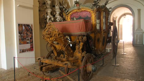 View-of-an-old-horse-drawn-carriage-inside-the-museum-in-the-Certosa-di-San-Martino-,-a-former-monastery-complex,-now-a-museum,-in-Naples,-Italy