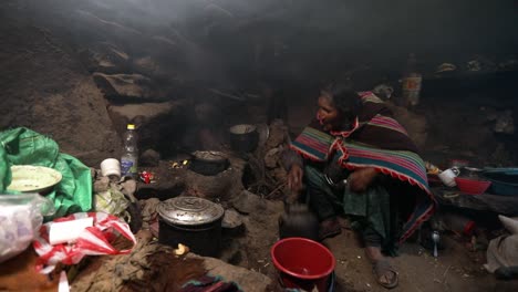 Inca-Woman-Wearing-Traditional-Poncho-Dress,-Pours-Water-in-Kettle