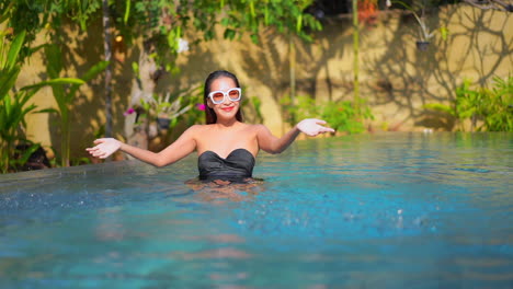 Happy-Smiling-Exotic-Woman-in-Swimming-Pool-Having-Fun-With-Water-and-Sunbathing,-Slow-Motion