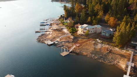 Aerial-shot-of-homes-with-private-docks-on-a-beautiful-lake-during-golden-hour