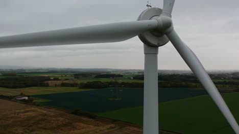 Slow-descending-shot-in-front-of-rotating-wind-turbine