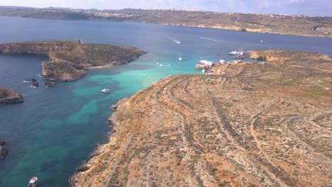 The-dry-island-landscape-of-Comino-and-the-warm-clear-water-of-Blue-Lagoon-seen-from-the-air