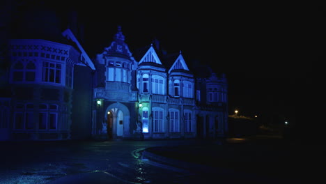 A-view-of-Bletchley-Park-house-at-night,-lit-up-with-coloured-lights-as-part-of-an-exhibition