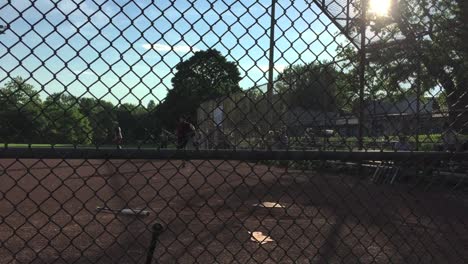 Spectator-POV-of-man-hitting-a-base-hit-during-community-baseball-at-Trinity-Bellwoods-Park-in-Toronto