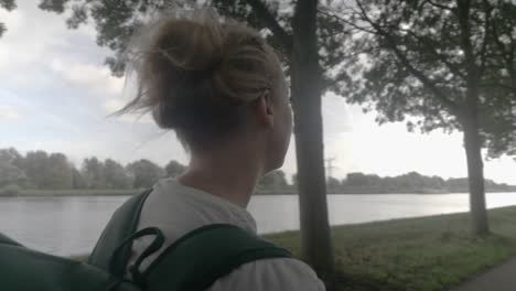 A-Close-up-of-a-Young-Woman-Backpacker-Admiring-the-Dutch-Countryside