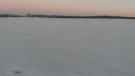 showing-snow-on-a-frozen-lake