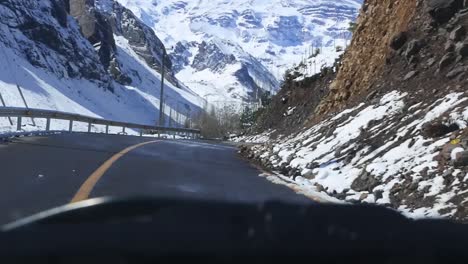 Cockpit-view,-cruising-between-snowy-mountains,-Chile