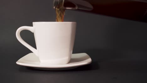 Pouring-french-press-coffee-into-white-cup---CLOSEUP