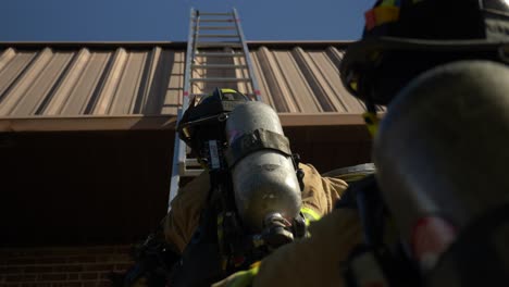 Firefighter-climbing-up-a-ladder-during-an-emergency-response-and-rescue-operation